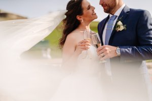 Newlyweds having a glass of champagne
