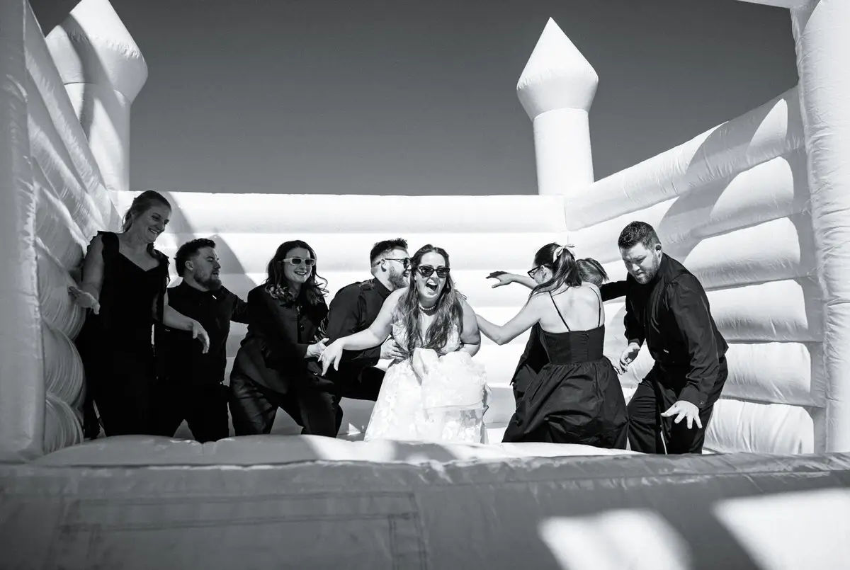 Bride and groom on a bounce house