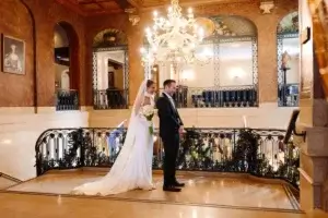 First look of the bride and groom at the top of the grand staircase in the Fairmont Chateau Frontenac
