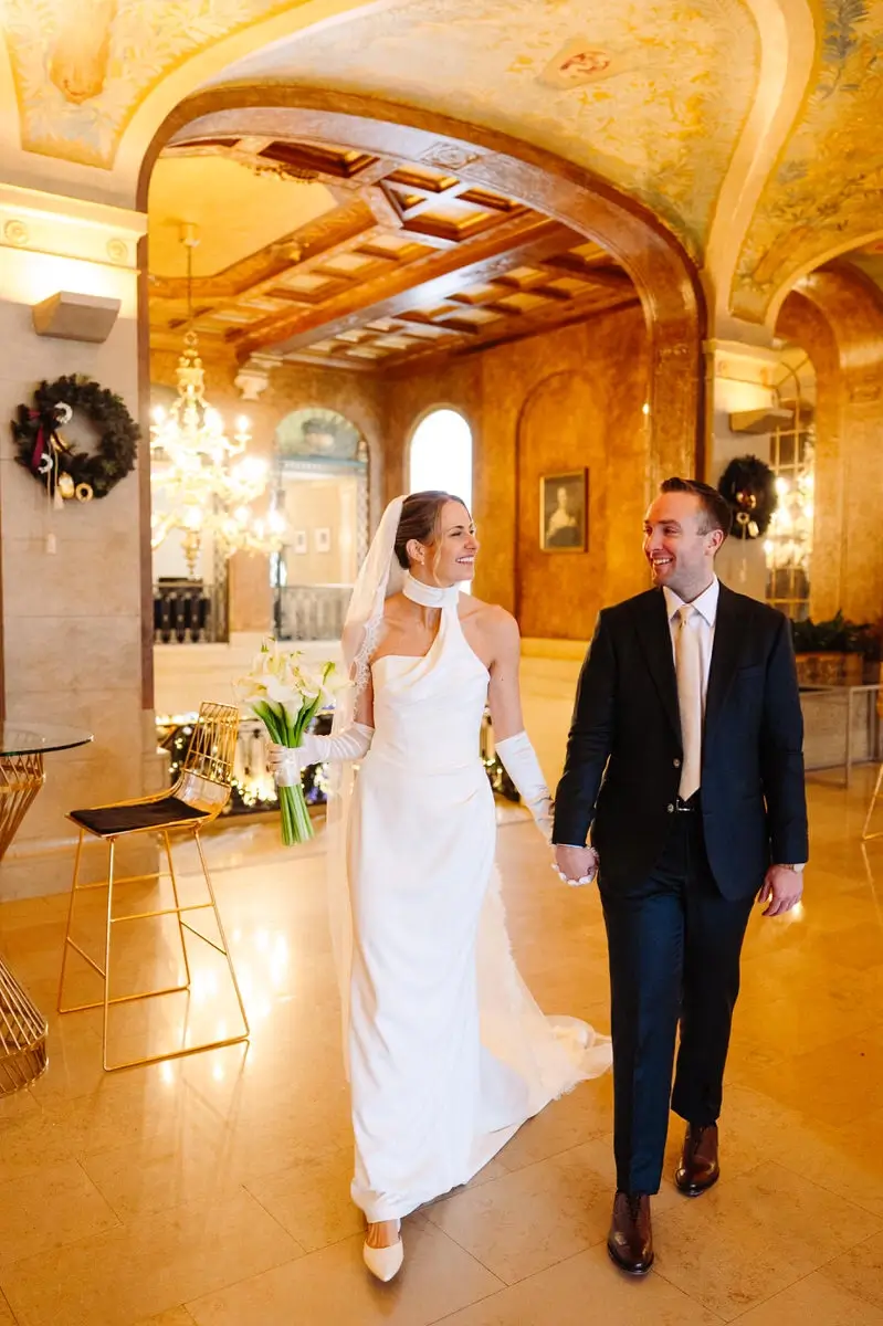 Bride and groom walk in the Verchere room at the Chateau Frontenac