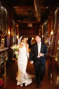 Bride and groom walking in front of the cellar in the Champlain Restaurant.
