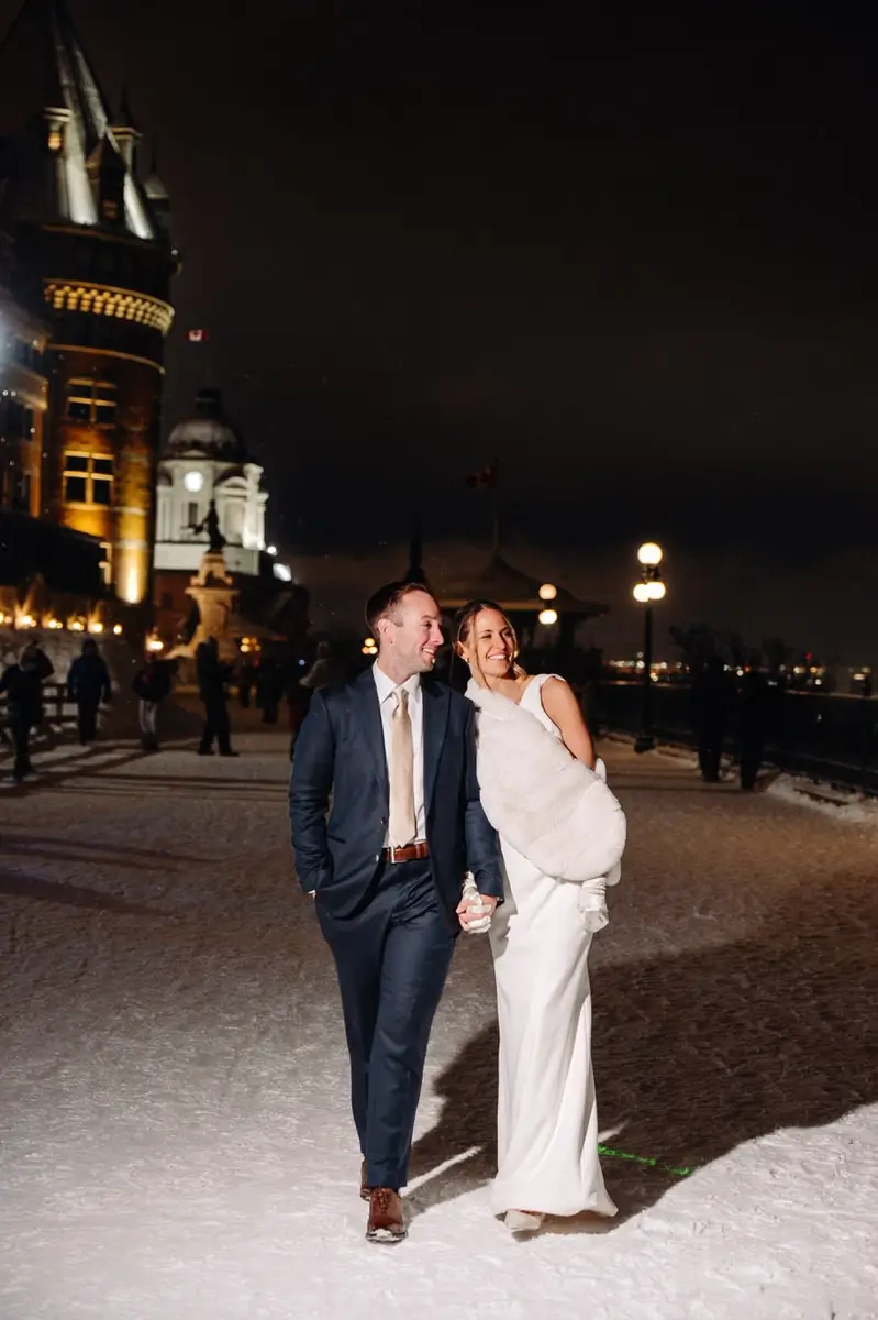Bride and groom walking on the Dufferin Terrace in Quebec City