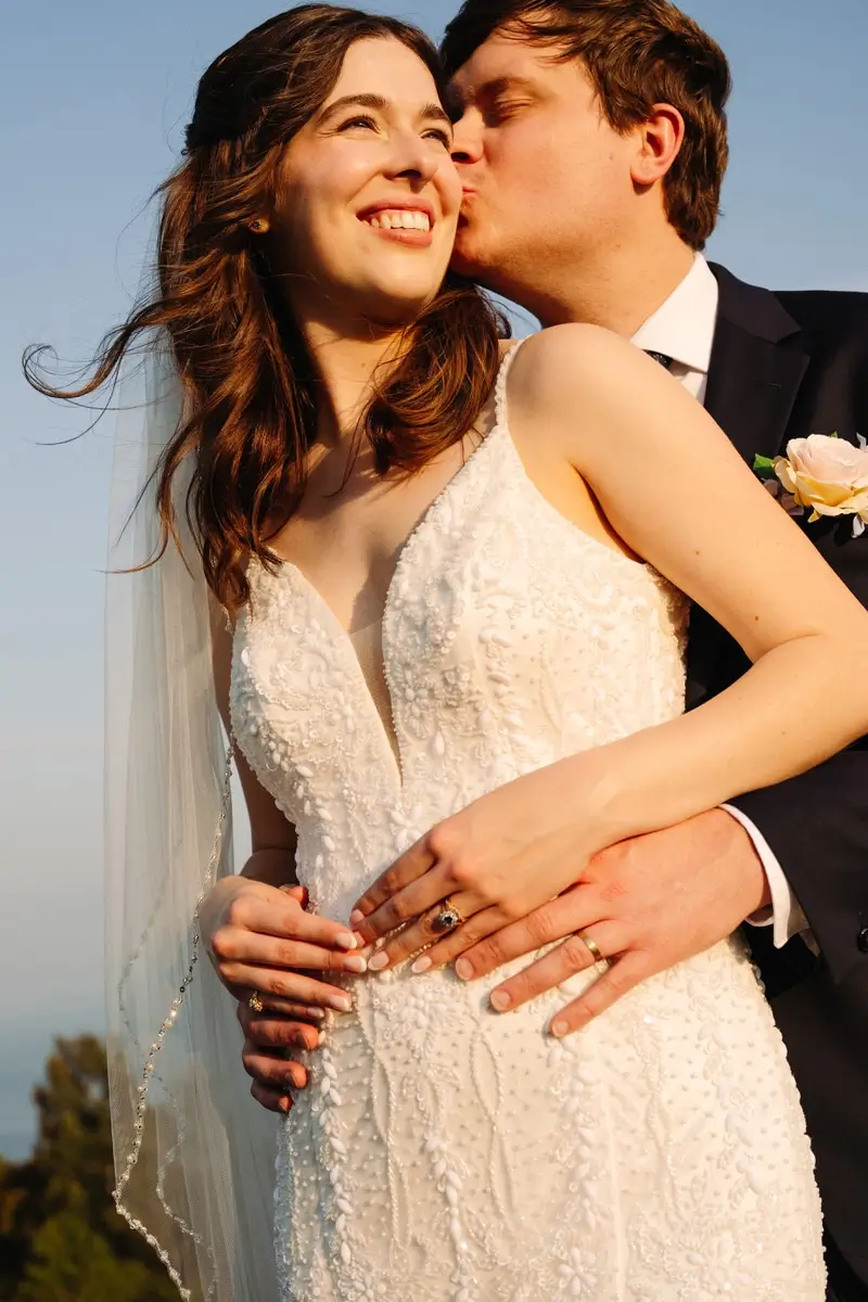 Bride and groom kissing at the sun set at the Manoir Richelieu