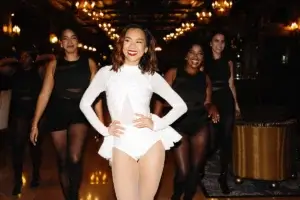 Bride who is a professional dancer walking the lobby of the Chateau Frontenac with her crew