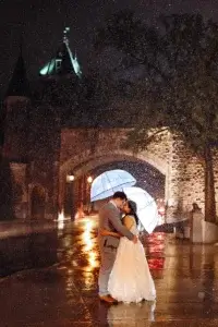 Bride and groom under the rain near the Gate Saint-Louis