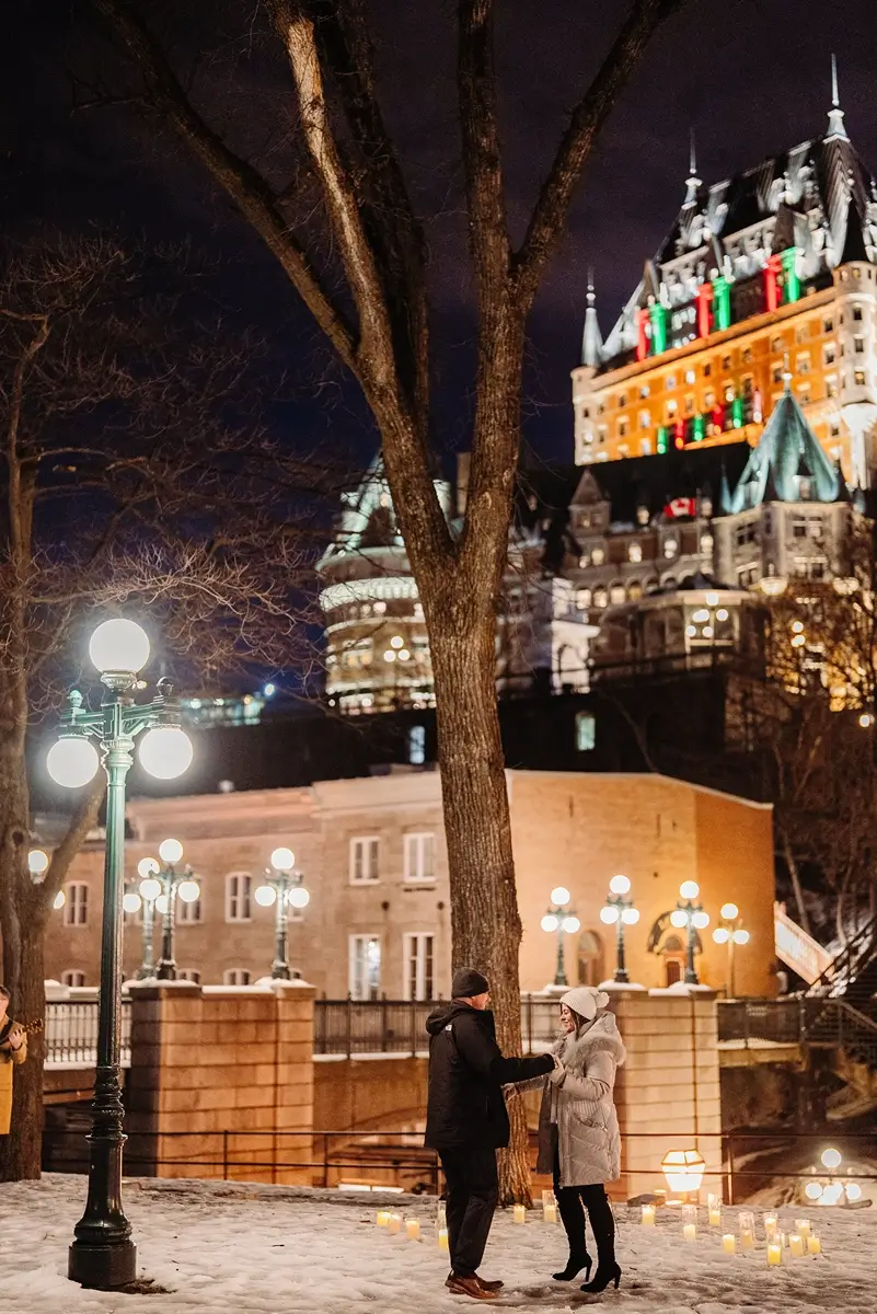Newly engage couple dancing with candles during winter