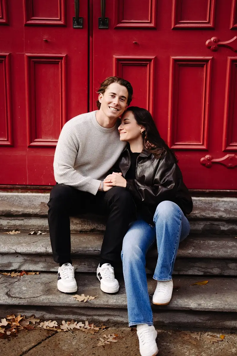 Lovers in front of a red door.